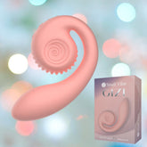 A peachy pink snail-shaped vibrator with a spiral design is displayed against a soft, bokeh background. The product box featuring the same design is positioned to the right of the Snail Vibe Gizi G-Spot Stimulator. The box reads "Snail Vibe GIZI" and "Unroll your pleasure" at the bottom.